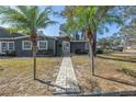 Inviting front exterior with brick walkway, palm trees, and a well-maintained lawn at 540 Villagrande S Ave, St Petersburg, FL 33707