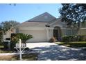 Lovely single-story home with a well-maintained lawn, two-car garage, and inviting front entrance at 5532 War Admiral Dr, Wesley Chapel, FL 33544