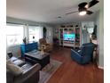 Spacious living room with hardwood floors, comfortable seating, and large aquarium at 568 Seacrest Dr, Largo, FL 33771