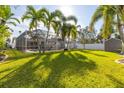 Relaxing pool area with screened enclosure and grassy backyard at 5720 Venetian Ne Blvd, St Petersburg, FL 33703