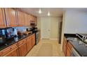 Well-equipped kitchen featuring ample cabinetry and granite counters at 6322 Palma Del Mar S Blvd # 401, Tierra Verde, FL 33715