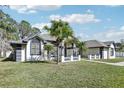 House exterior, palm trees, and a manicured lawn at 1010 Emerald Creek Dr, Valrico, FL 33596