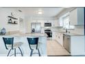 Modern kitchen with stainless steel appliances and white cabinets at 12391 70Th St, Largo, FL 33773