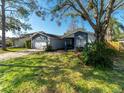 Two-story home with a large front yard, and a two-car garage at 15716 Country Lake Dr, Tampa, FL 33624