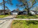 Newly painted home with a 2-car garage and spacious lawn at 15716 Country Lake Dr, Tampa, FL 33624