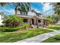 Two-story home with a wraparound porch and landscaping at 15927 Ternglade Dr, Lithia, FL 33547