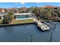 Waterfront property featuring a private dock and refreshing pool at 17020 Dolphin Dr, North Redington Beach, FL 33708