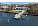 Aerial view of a waterfront home with a private dock and pool at 17020 Dolphin Dr, North Redington Beach, FL 33708