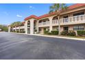 Condo building exterior showcasing Spanish-style architecture and landscaping at 1750 Belleair Forest Dr # A15, Belleair, FL 33756