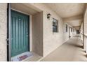 Building hallway with green door and neutral-colored walls at 1750 Belleair Forest Dr # A15, Belleair, FL 33756