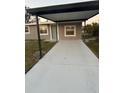 Inviting home exterior showcases a covered entrance and newly paved walkway, offering a welcoming approach to the front door at 1804 Cadillac Cir, Tampa, FL 33619