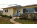 House entrance with blue metal railing and walkway at 1900 41St N St, St Petersburg, FL 33713