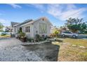 Beautiful home exterior showcasing well-maintained landscaping, a decorative water feature, and a spacious driveway at 2070 28Th St, Sarasota, FL 34234