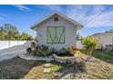 Home exterior with attractive landscaping, decorative water feature, and a freshly painted façade at 2070 28Th St, Sarasota, FL 34234