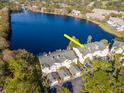 Beautiful aerial view of townhomes situated next to a serene lake and lush greenery at 2648 Sabal Springs Dr # 2, Clearwater, FL 33761