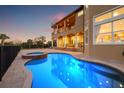 Inviting pool and spa with a large patio at sunset at 288 Mobbly Bay Dr, Oldsmar, FL 34677