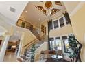 Elegant staircase with wrought-iron railings and high ceilings at 288 Mobbly Bay Dr, Oldsmar, FL 34677