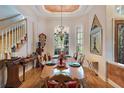 Formal dining room with a decorative chandelier and large windows at 2987 Wentworth Way, Tarpon Springs, FL 34688