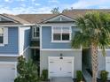 Blue exterior of townhome with white garage door at 3010 Palm Key Ave, Oldsmar, FL 34677