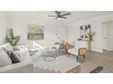 Living room with hardwood floors, a comfy sofa, and large windows at 3034 Burlington N Ave, St Petersburg, FL 33713