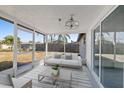 Relaxing screened porch with comfy seating and view of backyard at 3547 Garfield Dr, Holiday, FL 34691