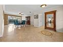 Elegant dining room with travertine flooring, large picture window, and classic furniture at 3903 Sand Dollar Pl, Tampa, FL 33634