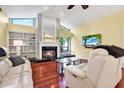 Living room featuring hardwood floors, fireplace, and recessed lighting at 393 Waterford E Cir, Tarpon Springs, FL 34688