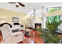 Living room with hardwood floors, a fireplace, and ample natural light at 393 Waterford E Cir, Tarpon Springs, FL 34688