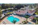 Aerial view of community pool area with spacious sun deck, lounge chairs, and a spa at 4210 Revere Cir, New Port Richey, FL 34653