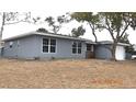 Gray siding, brick accents, and a spacious yard at 4645 Commodore Ave, Spring Hill, FL 34606