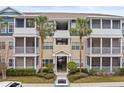 Tan condo building with balconies and palm trees at 4802 51St W St # 224, Bradenton, FL 34210