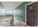 Interior condo hallway with green walls and a staircase at 4802 51St W St # 224, Bradenton, FL 34210