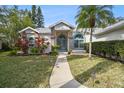 Charming front yard with a walkway leading to a beautiful home entrance and inviting curb appeal at 4833 Yellowstone Dr, New Port Richey, FL 34655