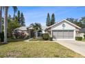 Inviting home with a well-manicured lawn and lush landscaping, creating a welcoming curb appeal at 4833 Yellowstone Dr, New Port Richey, FL 34655