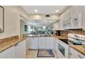 White kitchen with granite countertops and appliances at 6343 Palma Del Mar S Blvd # 225, St Petersburg, FL 33715