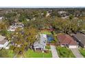 Aerial shot of a home with a screened pool and well-maintained landscaping at 705 W Kentucky Ave, Tampa, FL 33603