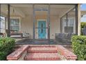 Screened porch with a swing and seating area at 834 11Th N St, St Petersburg, FL 33705