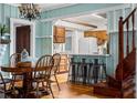 Cozy dining room with wooden table, chairs, and a view into the kitchen with breakfast bar at 10350 54Th N Ave, St Petersburg, FL 33708