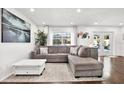 Relaxing living room with a gray sectional sofa and large windows at 1212 Markley Dr, Largo, FL 33770