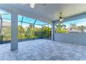 Spacious screened-in patio with tile flooring and ceiling fans at 13903 Natures Reserve Dr, Lithia, FL 33547