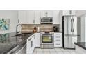 Modern kitchen with stainless steel appliances and granite countertops at 223 Sun Vista S Ct, Treasure Island, FL 33706