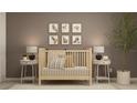 Bedroom with crib, nightstands and animal wall art at 5210 Meyer Bessie St, Zephyrhills, FL 33541