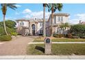 Stunning two-story home with brick facade and lush landscaping at 5308 E Longboat Blvd, Tampa, FL 33615