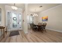 Bright dining area with hardwood floors and entryway view at 5571 Rock Dove Dr, Sarasota, FL 34241