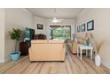 Spacious living room with hardwood floors and pool access at 5571 Rock Dove Dr, Sarasota, FL 34241