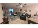 Open-concept living room with tile flooring, ceiling fans and comfortable furniture at 5880 38Th N Ave # 204, St Petersburg, FL 33710
