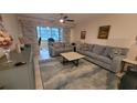 Cozy living room featuring plush couches, textured rug, and a view to an office at 5880 38Th N Ave # 204, St Petersburg, FL 33710