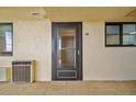 Condo entry with screen door and adjacent AC unit at 5915 Sea Ranch Dr # 308W, Hudson, FL 34667