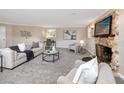 Living room with stone fireplace and comfy seating area at 6923 Dartmouth N Ave, St Petersburg, FL 33710