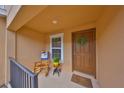 Inviting front porch with rocking chair and potted plants at 7134 Merlot Sienna Ave, Gibsonton, FL 33534